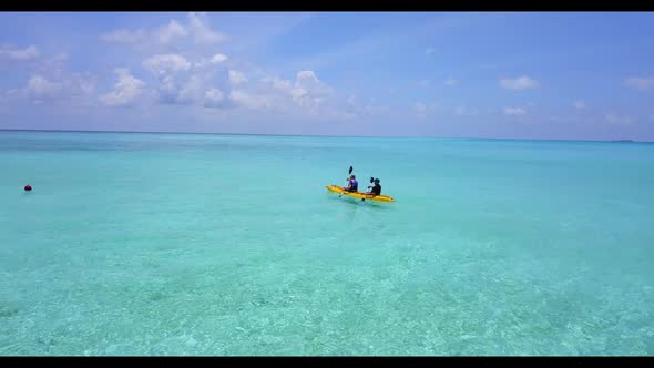 Two people tan on luxury resort beach adventure by aqua blue ocean and white sand background of the 