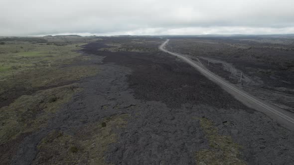 Aerial flyover above dried lava field running along Saddle Road in Hawaii.