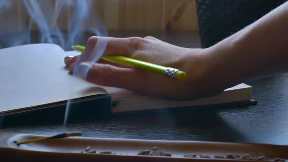 the Girl Writer Begins to Write a Book and Writes a Pencil in a Notebook There is an Incense Stick