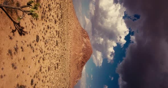 Storm clouds gathering over a butte in California Mojave Desert, VERTICAL