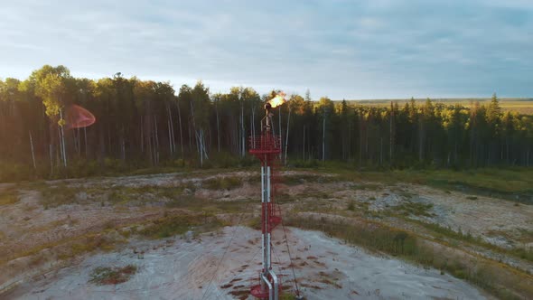 A Drone Flies Around a Burning Torch at an Oil Field in Canada