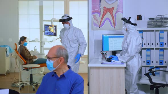 Stomatologist in Protective Suit Asking for Patient Dental Xray