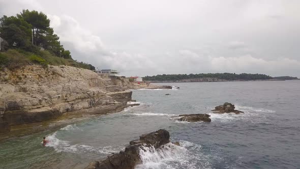 Fly Through The Rocky Shore With Several People During Storm