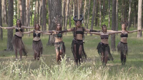 Group of Women Dancers with Make-up and in Mystical Fabulous Costumes Dancing Groovy Dance in Color