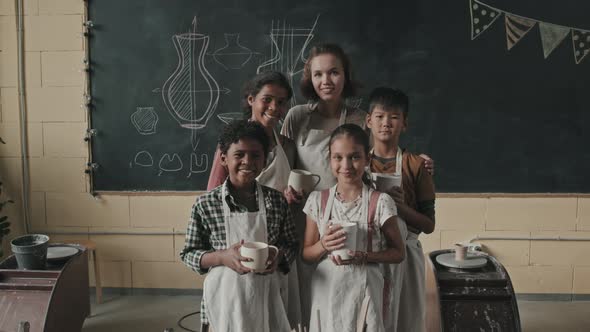 Woman and Kids Posing with Ceramic Crafts