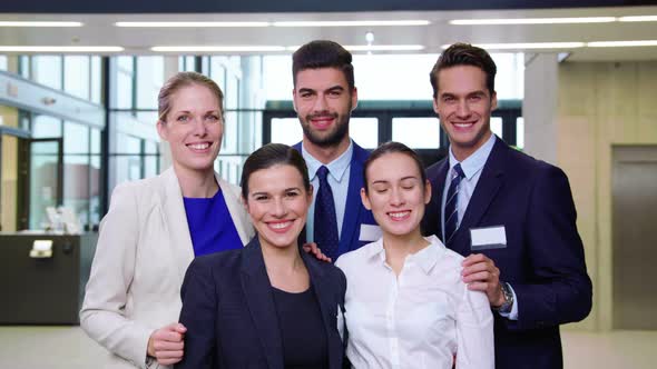 Smiling businesspeople showing thumbs up in office