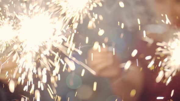 Asian Girl and Group Young College Student Friends Lit Light Sparkler in Hand Fireworks Sing and