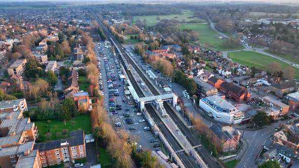 Commuter Train Approaching a Station in the UK Aerial View