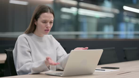 Woman Reacting to Loss While using Laptop