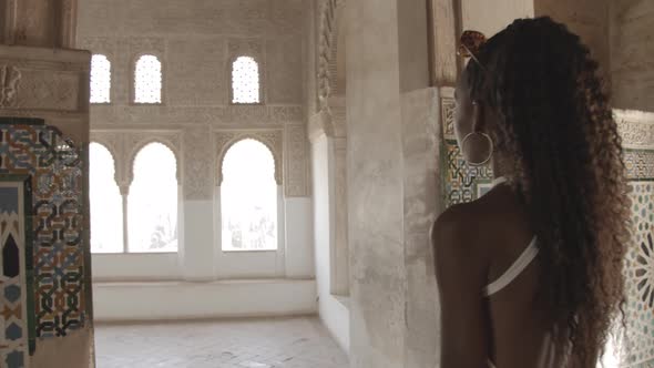 Female Tourist In Tiled Alhambra Interior