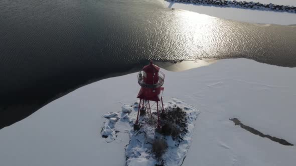 4k drone video of Alpena Michigan Lighthouse in winter.