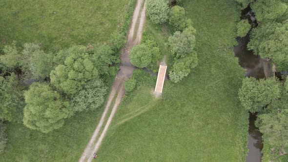 Wooden bridge over a river in a dense forest