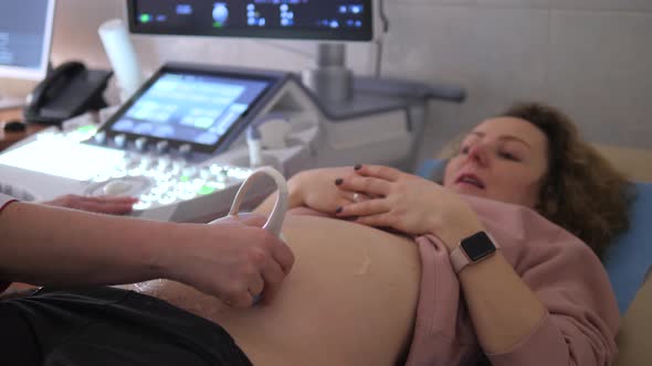 Pregnant Woman Having Ultrasound Scan At Medical Clinic