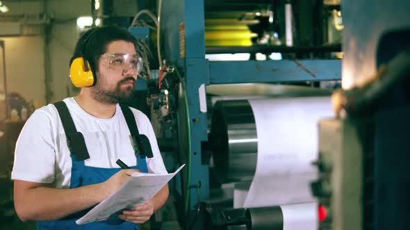 Typography Expert Is Observing the Working Process. Engineer, Worker at Factory Facility.