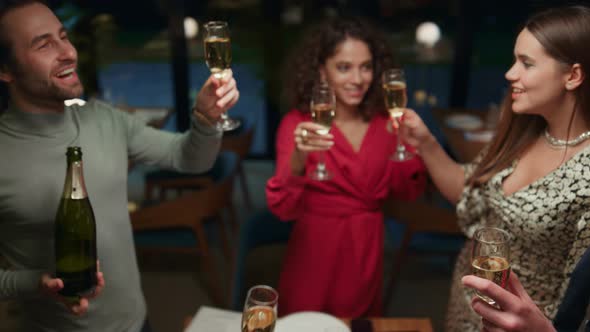 Multiethnic Group Drinking Champagne in Restaurant