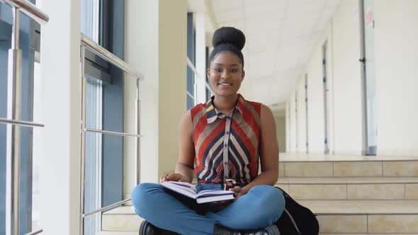 African American Woman Student with a Books in the University