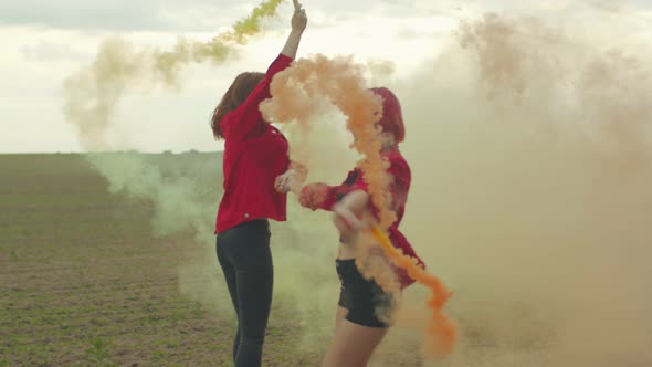 Joyful Women in Colored Smoke Skipping Down Road