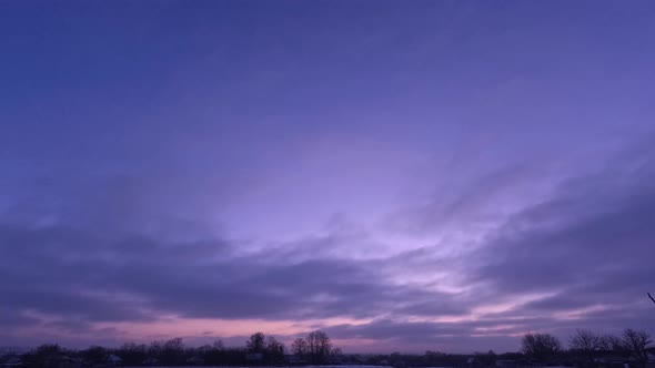 Time lapse sunrise and clouds. Purple beautiful sky in winter.