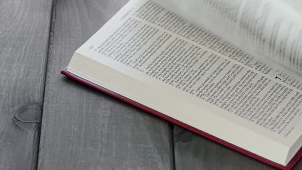 Close Up of Leafing Book Pages on Gray Wooden Table