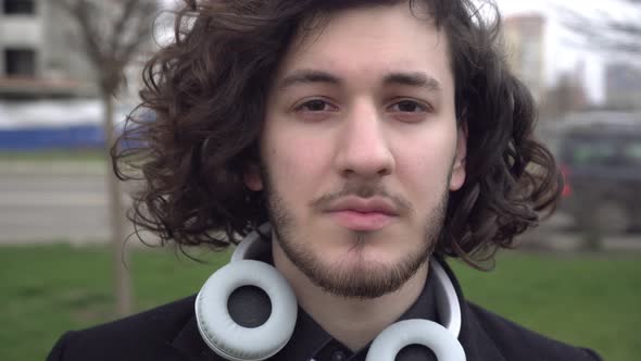 Portrait of a Young Curly Haired Brunette Man