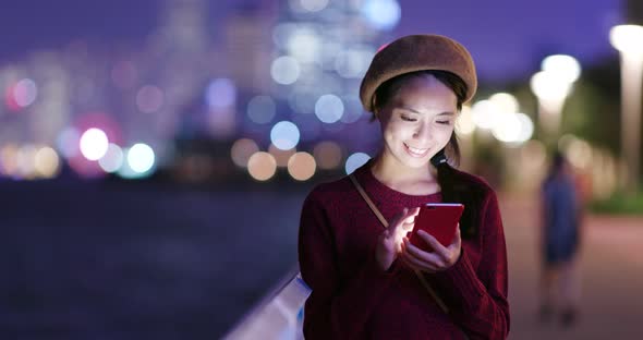 Woman use smart phone online at night