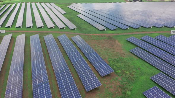 Aerial View of Green Field with Solar Energy Panels for Renewable Electricity Production