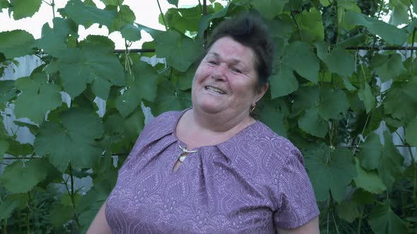 Happy smiling mature woman singing to the camera. Portrait of happy pensioner woman. Old generation