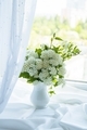 A vase with spring flowers stands on the windowsill near the window - PhotoDune Item for Sale