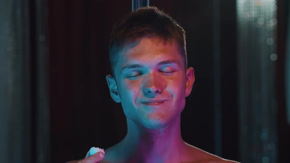 Shirtless Man Eating Coconut Candy and Acting Sexy  Neon Blue and Purple Lighting