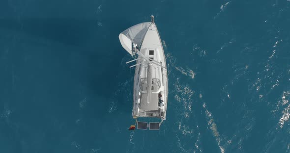 Yacht with Reflection Sailing on Open Sea Aerial