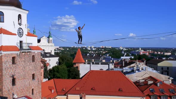 Man Balances on Tight Rope a View of the City From Height