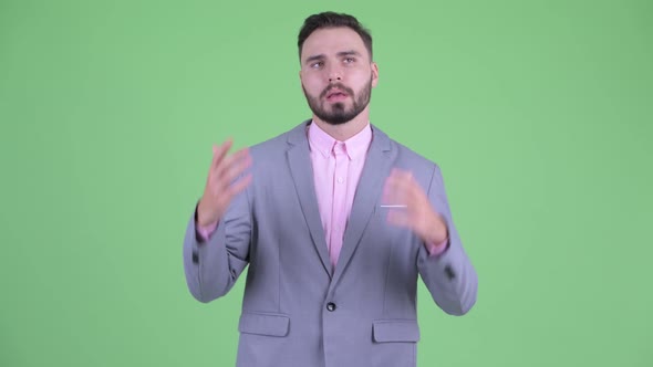 Stressed Young Bearded Businessman Looking Bored and Tired