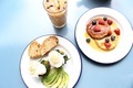 Brunch with pancakes, avocado, toast and poached eggs from above - PhotoDune Item for Sale