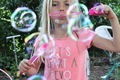 Girl blowing bubbles in spring - PhotoDune Item for Sale