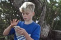 Boy playing on a smart phone in the forest  - PhotoDune Item for Sale