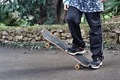 Close up of feet and skateboard on a road  - PhotoDune Item for Sale