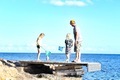 Father and kids crabbing and catching fish with nets on a jetty by the sea - PhotoDune Item for Sale