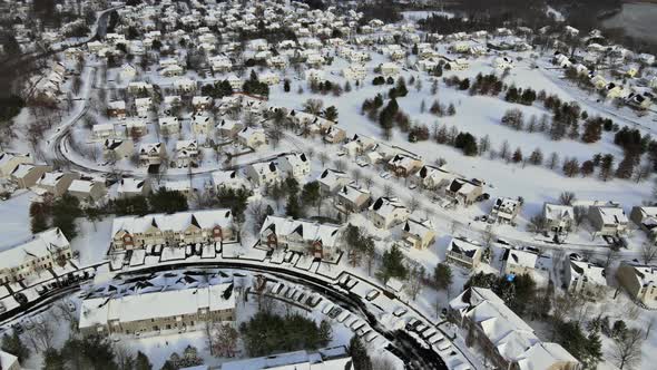 Aerial View Over Private Houses in Wintertime of Snow Covered Traditional Housing Suburbs