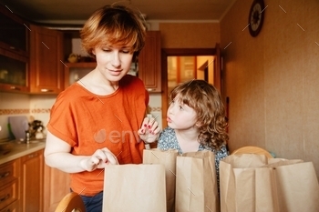 Family sorting delivery food at kitchen