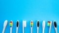 Black white and rainbow bamboo toothbrushes on blue background - PhotoDune Item for Sale