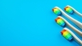 Rainbow bamboo wooden toothbrushes on blue background - PhotoDune Item for Sale