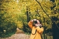 Woman making photos at the autumn forest. - PhotoDune Item for Sale
