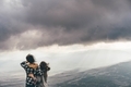 Couple on top of a mountain enjoying valley view before sunset.  - PhotoDune Item for Sale