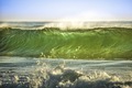 A green wave rolls in to the beach showing the beauty and the power of the ocean  - PhotoDune Item for Sale