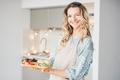 Woman holding fruit at the kitchen. - PhotoDune Item for Sale