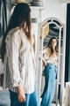 Woman choosing clothes and looking at the mirror. - PhotoDune Item for Sale