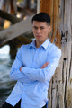 A male model poses against a wooden pier  - PhotoDune Item for Sale