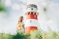 Women standing near lighthouse. - PhotoDune Item for Sale