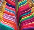 Two rows of colourful clothes hanging in a shop - PhotoDune Item for Sale