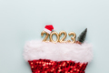 New year 2023 number, golden digits and santa hat over blue background. - PhotoDune Item for Sale
